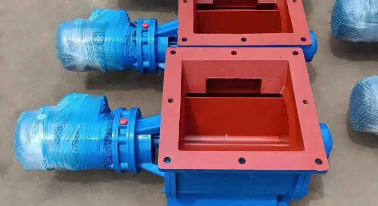 Two blue and red painted Rotary Valves are placed on the concrete floor.